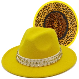Detail of yellow fedora hat showing rhinestone-studded band and leopard print lining