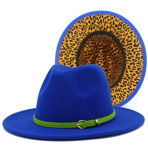Detail of royal blue fedora hat showing green belt buckle and leopard print lining