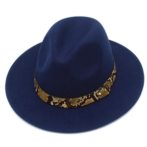 Close-up of navy blue wool fedora featuring snake skin leather band and gold rivet detail
