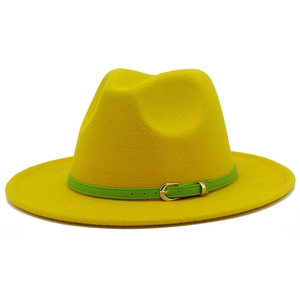 Close-up of vibrant yellow wool jazz hat with a green leather belt and gold buckle detail