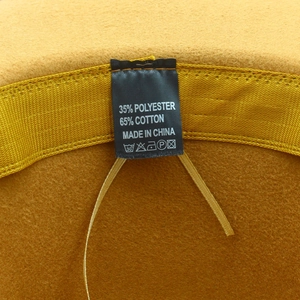 Detailed label showing 65% cotton and 35% polyester material composition on yellow felt hat