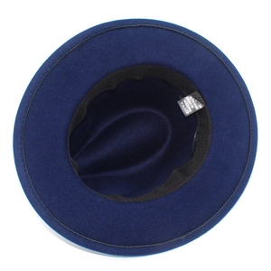 Detail view of navy blue fedora hat interior showing cotton blend lining and care labels