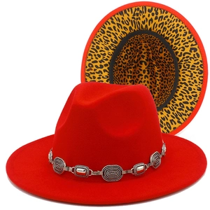 Detail of red fedora hat featuring vintage silver chain and leopard print lining