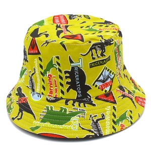 Yellow cotton bucket hat for adults featuring cartoon dinosaur prints and danger signs