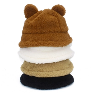 Vertical stack of plush bear ear bucket hats in brown, white, khaki, and black colors