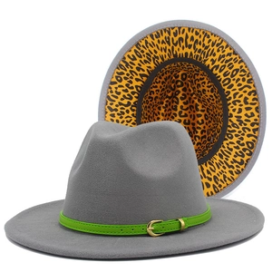 Detail view of grey fedora hat featuring a green leather band and leopard print lining