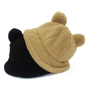 Close-up of plush teddy fleece texture and bear ears on black and khaki bucket hats