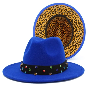 Detail of blue fedora with colorful rhinestones on black band and leopard print underbrim