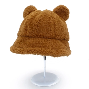 Detail of soft brown plush teddy bucket hat showing fuzzy bear ears and thick texture