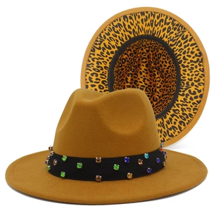 Detail of yellow wool fedora featuring colorful rhinestones and leopard print brim