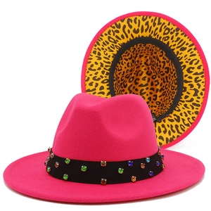 Detail of fuchsia fedora hat featuring colorful rhinestones and leopard print lining