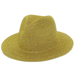 Detailed view of golden woven straw fedora hat featuring metallic luster and dense texture