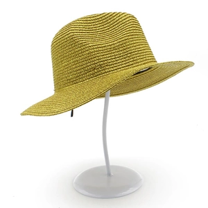 Close-up of golden Panama straw hat with metallic finish and spiral woven details