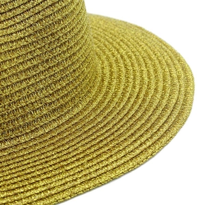 Close-up of the intricate spiral woven metallic fiber on the gold Panama straw hat