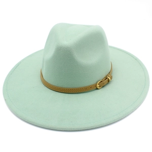 Macro shot of mint green wool fedora with brown leather band and gold buckle detail
