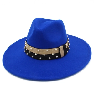 Detail of royal blue fedora hat featuring a gold trim band with white pearls and rhinestones