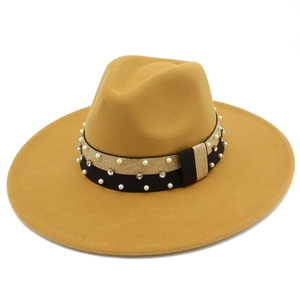 Detailed shot of camel wool fedora hat featuring pearl and rhinestone studded ribbon band