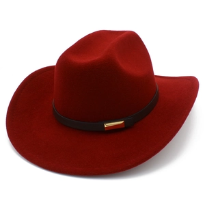 Detail of burgundy wool felt cowboy hat with black leather band and gold metal buckle