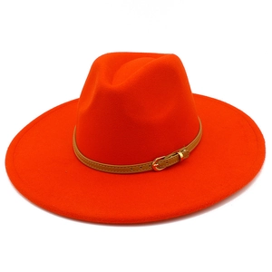 Detail view of orange wool fedora hat with wide brim and leather band with metal buckle