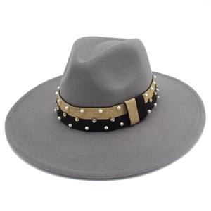 Detail view of grey wide brim fedora with gold-black ribbon, pearls, and rhinestones