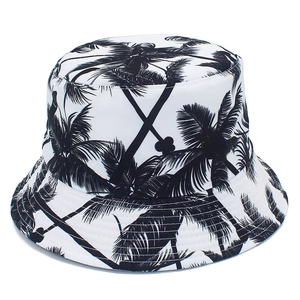 White reversible canvas bucket hat with black palm tree print for outdoor sun protection