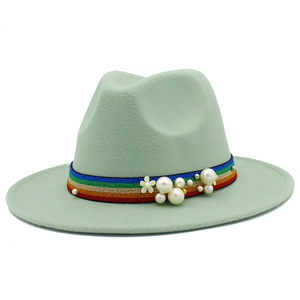 Detail of light green wool fedora hat with rainbow ribbon and white pearl accents