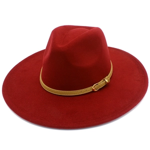 Detail of burgundy wool fedora hat with a khaki decorative band and golden metal buckle