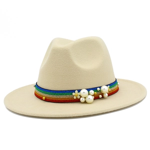 Detail of beige wool fedora hat with rainbow ribbon featuring pearls and floral studs