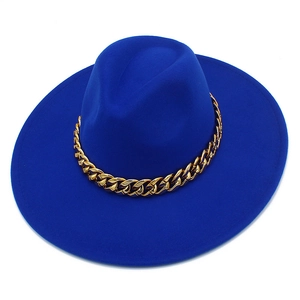 Détail de la chaîne en métal doré sur le chapeau à bord large bleu royal de style élégant