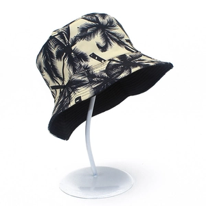 Detail of tropical palm tree print on a reversible cream canvas bucket hat with stitching