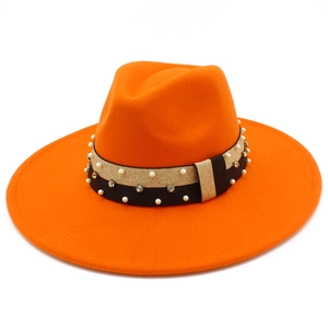 Detailed macro view of orange wool fedora featuring pearl and rhinestone ribbon decoration