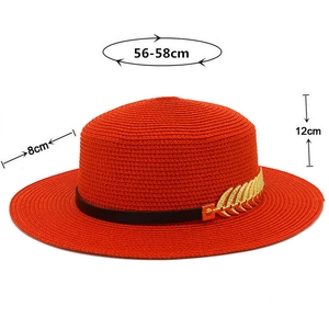 Detail of bright orange straw fedora hat with black band and gold leaf ornament measurements