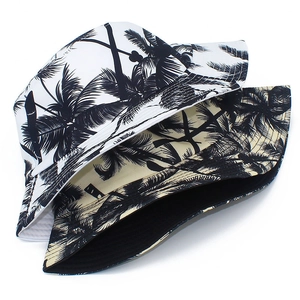 Close-up of reversible cotton canvas bucket hat featuring tropical coconut tree print detail