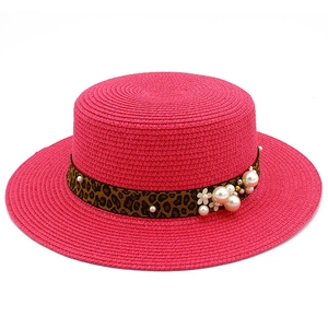 Elegant wide brim straw sun hat with leopard print ribbon and pearls for beach vacation