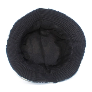 Top down view of double-sided canvas bucket hat with coconut palm print and black lining