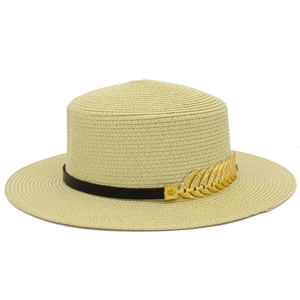 Detail of flat top straw hat with black band and gold feather buckle accessory