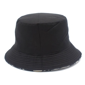 Detailed view of black bucket hat with reinforced stitching and reversible coconut print