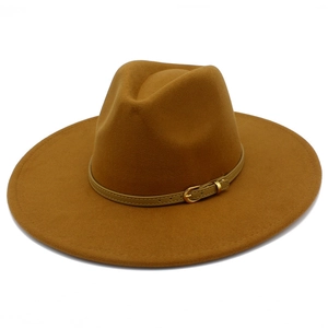 Macro detail of camel wool fedora hat featuring a thin leather band with gold metal buckle