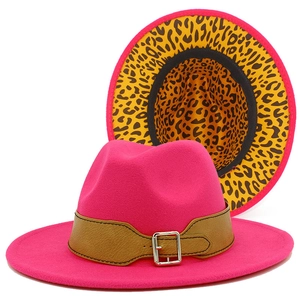 Detail of rose pink fedora hat with brown leather strap and leopard print lining