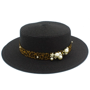 Detail of black boater hat with leopard ribbon, pearls and floral embellishments