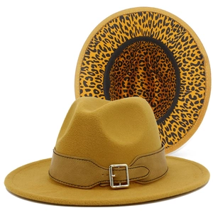 Detail of fedora hat showing mustard yellow felt and leopard print lining with leather belt
