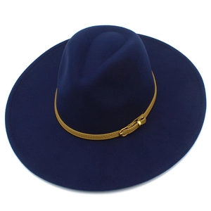 Detail of dark blue wide brim wool fedora hat with brown leather belt and gold buckle