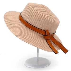 Classic straw sun hat with brown faux leather band and white stitching on a metal stand