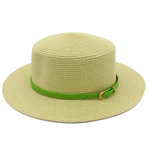 Close-up of beige straw hat featuring fine woven texture and green leather belt buckle
