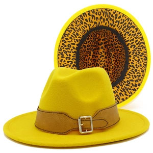 Detail of yellow wool felt fedora featuring brown leather belt and leopard print brim
