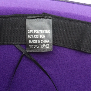 Detailed interior of purple felt fedora hat with black sweatband and fabric care label