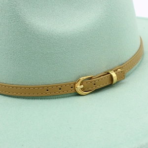 Detail of mint green wool felt fedora featuring leather band with gold oval buckle