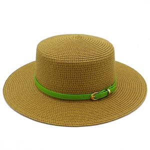 Close-up of flat top straw hat with wide brim and green leather belt with gold buckle
