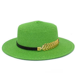 Detail of green straw sun hat featuring black band with gold leaf metal accents