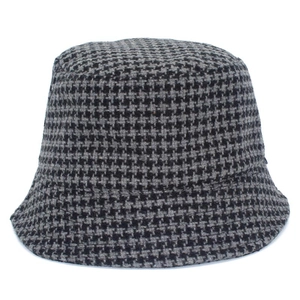 Classic houndstooth bucket hat in black and grey thick knit fabric on white background